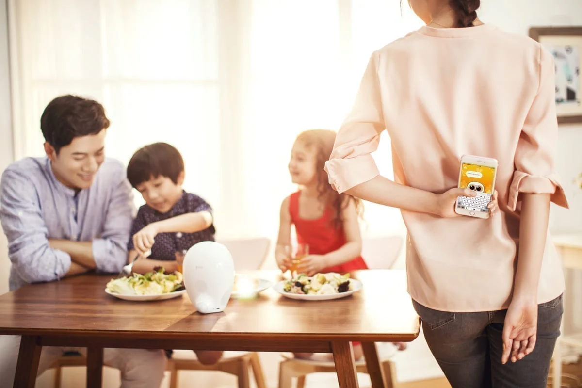 A family at the dinner table with picture books, screens away